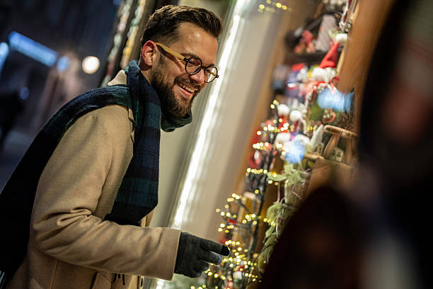 istock Man shopping window at night during christmas season 2245170461