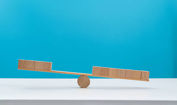 istock Blank cubes on wooden seesaw 2245173897