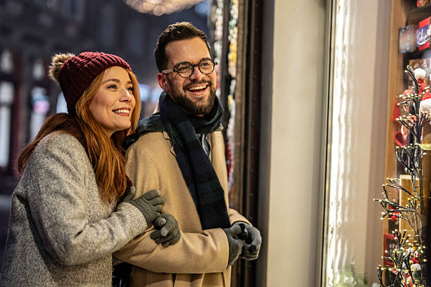 istock Smiling couple enjoying christmas window shopping at night 2245174190