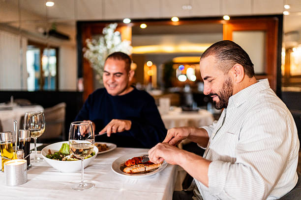 istock Gay couple eating during dinner at restaurant 2245176149