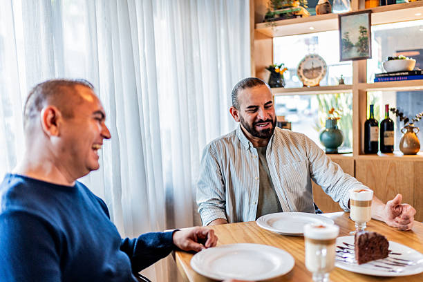 istock Gay couple talking on coffee shop 2245177568
