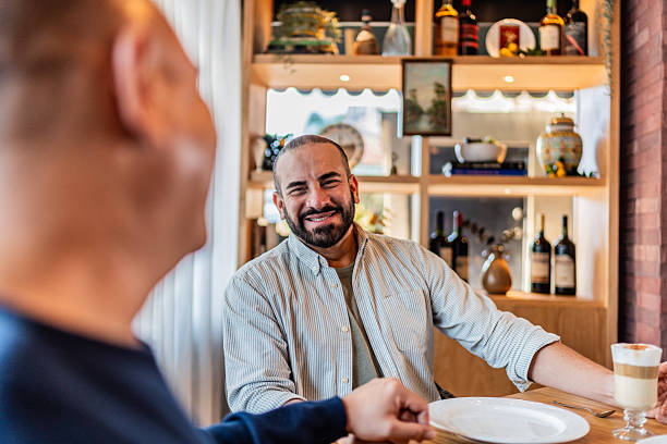 istock Mature man talking to husband at coffee shop 2245177599