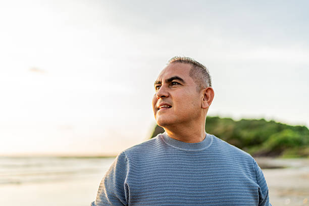 istock Mature man looking at ocean view during golden hour on beach 2245177650