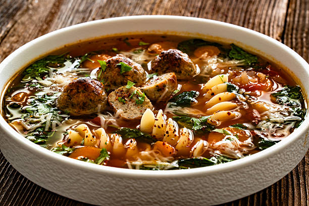 istock Italian Meatballs Wedding Soup on wooden table 2245181410
