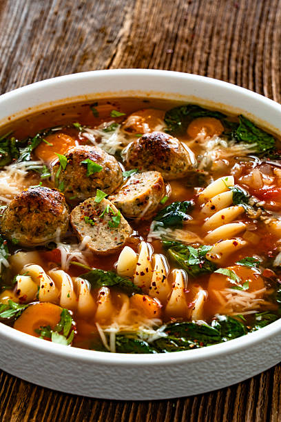 istock Italian Meatballs Wedding Soup on wooden table 2245181437