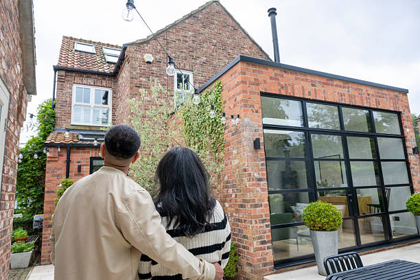 istock British Pakistani couple standing outside house, rear view 2245182518