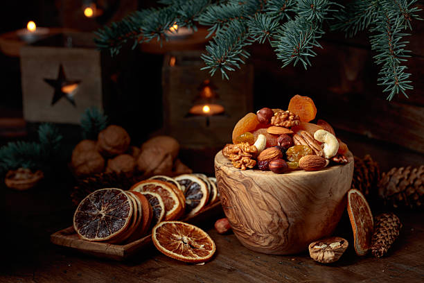 istock Dried fruits and assorted nuts on an old wooden table. 2245184363