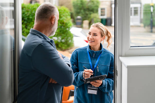 istock Friendly conversation at the door between a service representative and a customer during a sunny day 2245186175