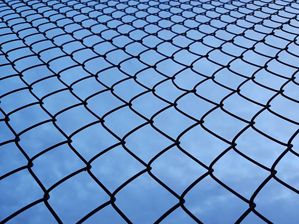 istock Chain Link Fence Silhouette 2245188123