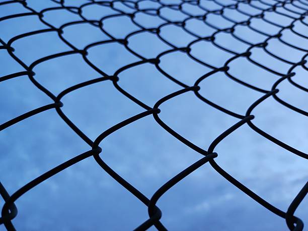 istock Chain Link Fence Silhouette 2245188137