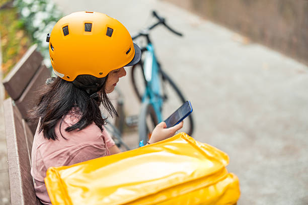 istock Delivery woman checking smartphone for next route 2245188161