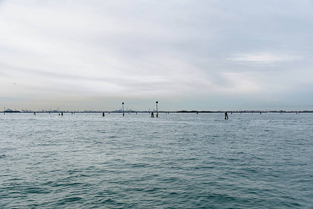 Serene ocean view with distant horizon and calm waters under overcast sky