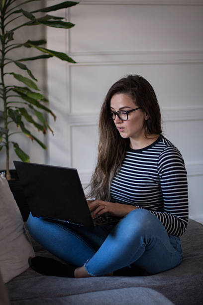 istock Young female freelancer working from home on her laptop computer. 2245189858
