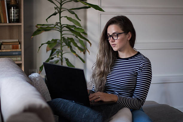 istock Young female freelancer working from home on her laptop computer. 2245189860