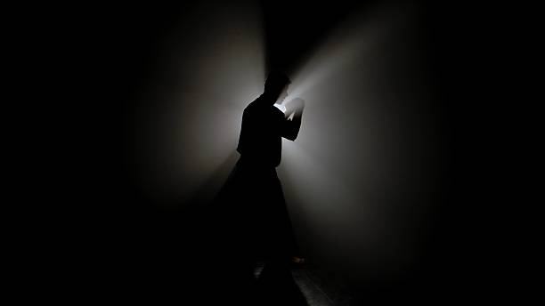 istock A Shadowed Figure a Martial Artist Illuminated by Bright Light 2245190935