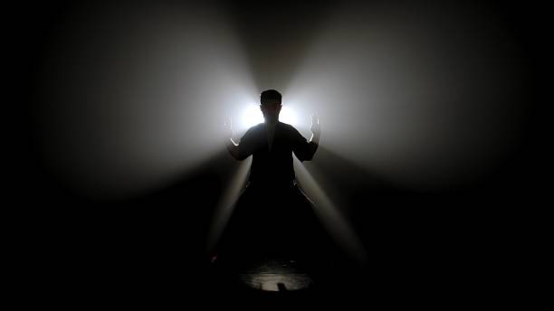 istock A Shadowed Figure a Martial Artist Illuminated by Bright Light 2245191197