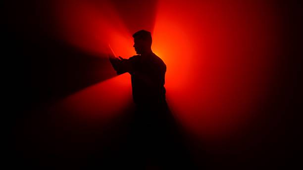 istock A Shadowed Figure a Martial Artist Illuminated by Bright Red Light 2245192375