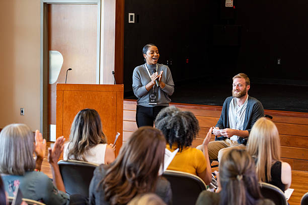 istock Engaging speaker addresses diverse audience in an indoor conference setting. 2245192492