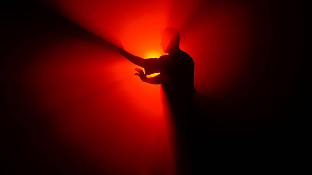 istock A Shadowed Figure a Martial Artist Illuminated by Bright Red Light 2245192556