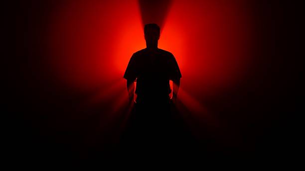 istock A Shadowed Figure a Martial Artist Illuminated by Bright Red Light 2245192957