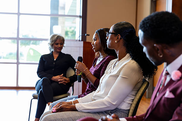 istock Diverse panel of speakers engage in thoughtful discussion at indoor event. 2245193671