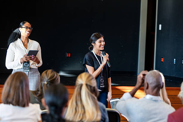 istock Diverse speakers engage audience with presentations at a conference. 2245193708