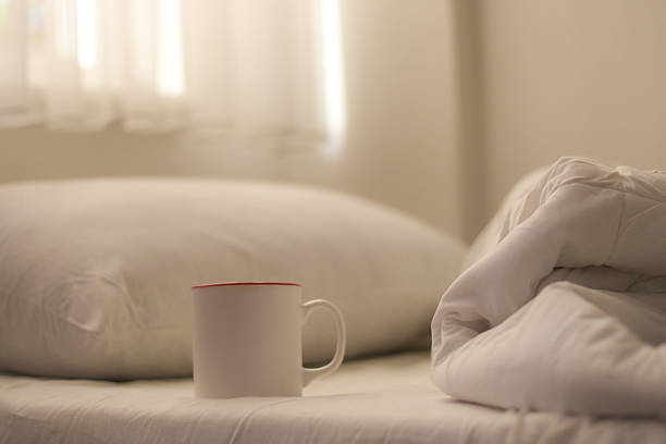 istock Minimal Morning Scene with Coffee Cup on Bed 2245193915