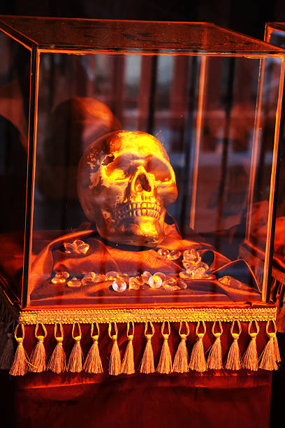 Halloween decoration - a golden skull in a glas box