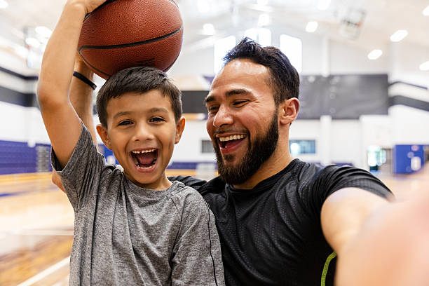 istock Father and son joyfully celebrating with a basketball after a game or practice 2245196643