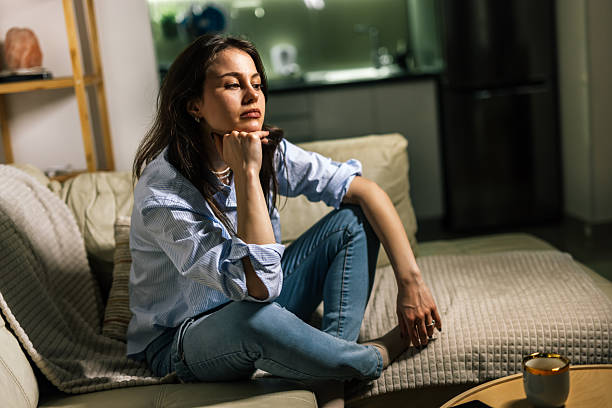 istock Young woman struggling with depression at home 2245198048