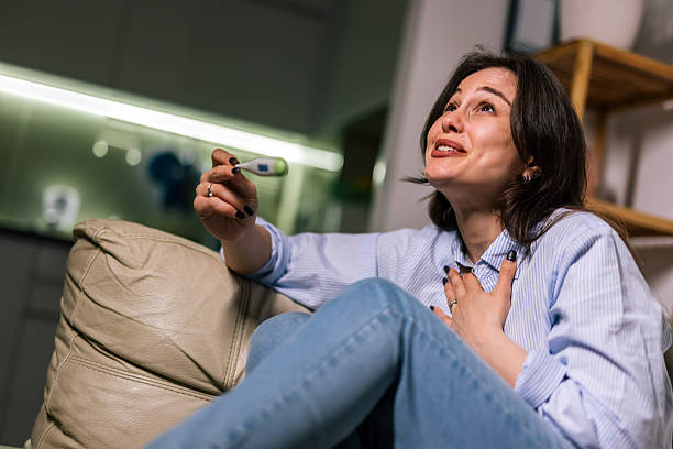 istock Young woman joyful after positive pregnancy test 2245198165
