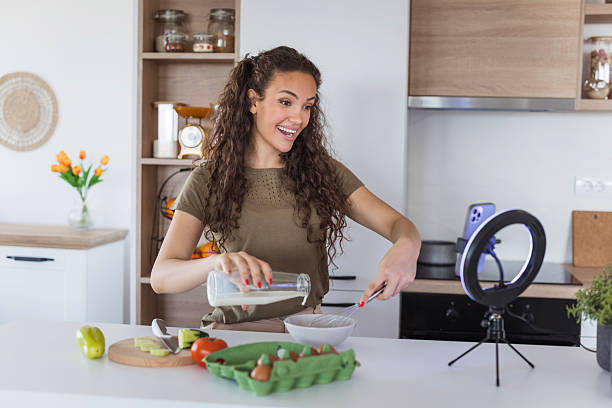 istock Young woman vlogger recording cooking video in kitchen 2245204638