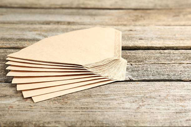 istock Many paper coffee filters on wooden table, space for text 2245205353