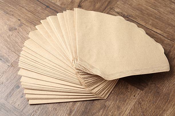 istock Many paper coffee filters on wooden table 2245205357