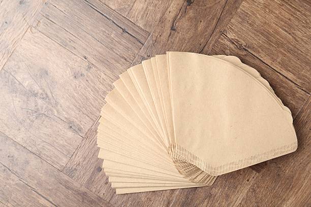 istock Many paper coffee filters on wooden table, top view 2245205431