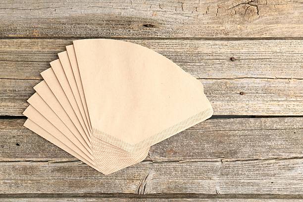 istock Many paper coffee filters on wooden table, top view. Space for text 2245205456