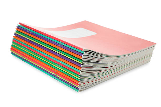 istock Stack of colorful copybooks isolated on white 2245205759