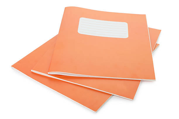 istock Orange copybooks isolated on white. School stationery 2245205817
