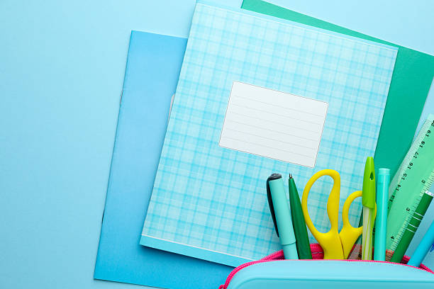 istock Copybooks and other school stationery on light blue background, flat lay 2245205890