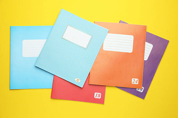 istock Colorful copybooks on yellow background, flat lay 2245205893