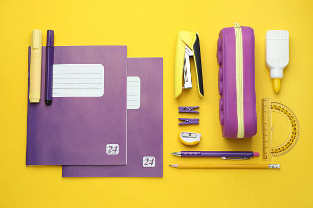 istock Copybooks and other school stationery on yellow background, flat lay 2245205905