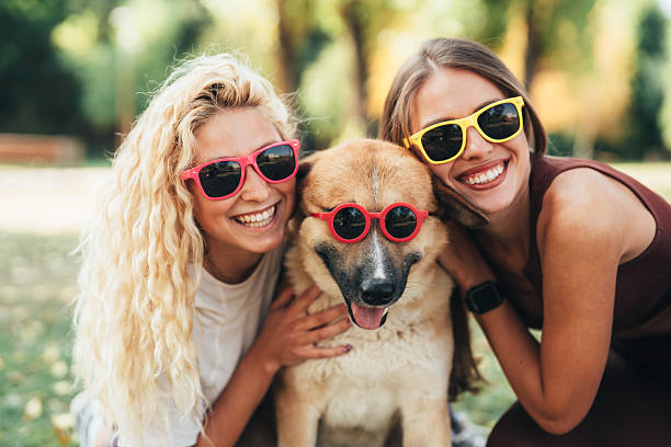 istock Best friends having fun with their cool dog 2245206086