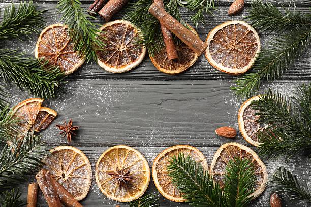 istock Frame of different aromatic spices and fir tree branches on grey wooden table, flat lay with space for text. Christmas season 2245206262