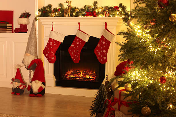 istock Stylish fireplace, Christmas tree with festive decor and presents indoors 2245206290