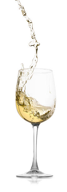 istock Tasty wine splashing in glass on white background 2245207730