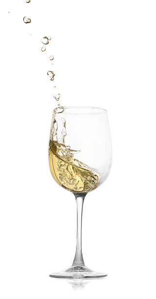 istock Tasty wine splashing in glass on white background 2245207807