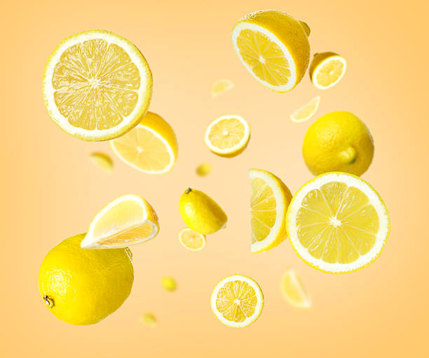 istock Fresh ripe lemons swirling in air against beige background 2245208090