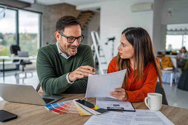 istock Designers collaborating on office project discussing color swatches 2245210335