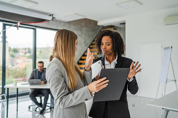 istock Businesswomen collaborating on document, discussing successful project results 2245210582