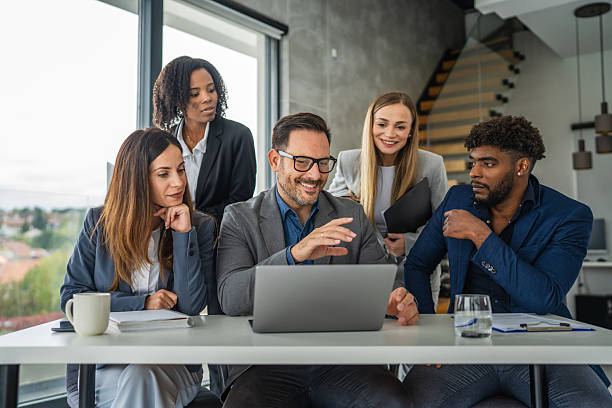 istock Business team collaborating on laptop during office meeting 2245210592
